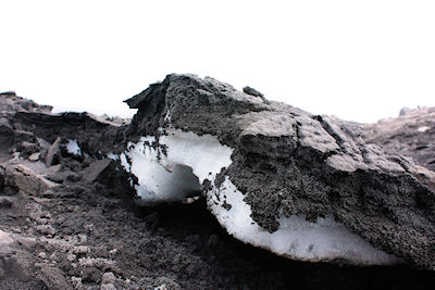 A layer of volcanic ash from Eyjafjöll on top of snow in the Fimmvörduhals pass - photographed on 17 June 2010